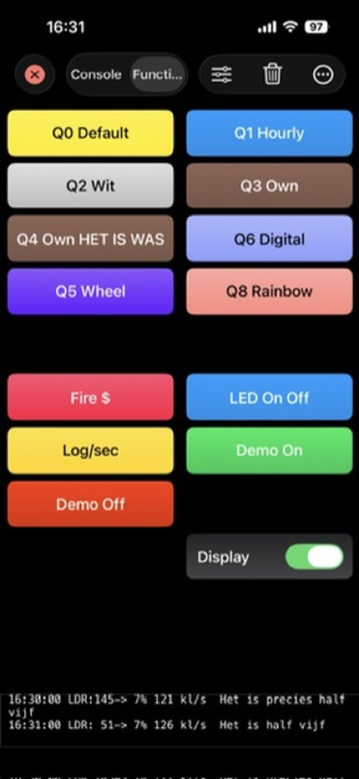 A full grid of buttons in dark mode with a Display toggle switch and live readings in the strip below